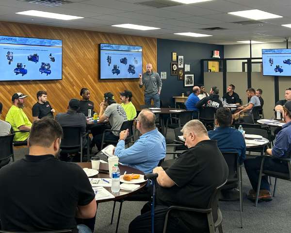 Full room shot Kyle Curran giving a presentation in the General Air Products Training Facility 
